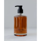 Bottle of Nyeok body wash with a pump on a light gray background