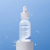 Aestura skincare serum bottle on a blue background