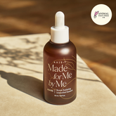 Brown bottle with dropper labeled 'Made for Me by Me' on a wooden surface, with 'Animal Test-Free' logo.