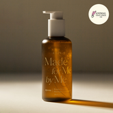 Brown bottle with pump labeled 'Made for Me by Me' on a neutral background