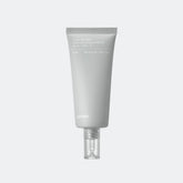 Skincare tube labeled 'delmax' on a light gray background