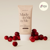 Tube of AXIS-Y sunscreen with red berries on a beige background