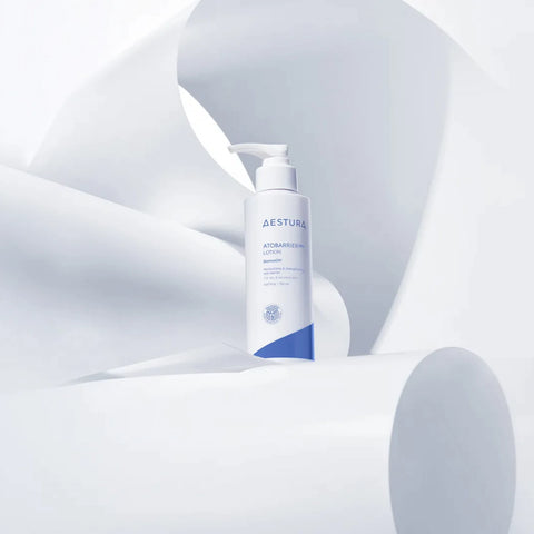 Aestura lotion bottle on a soft gray background