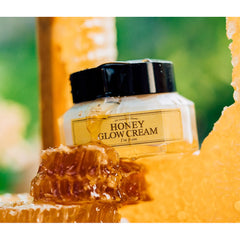 Jar of 'Honey Glow Cream' with honeycomb and honey on a blurred natural background