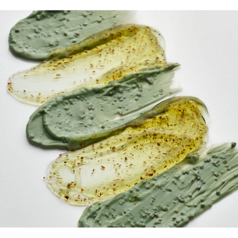 Three swatches of green and yellow cream on a white background