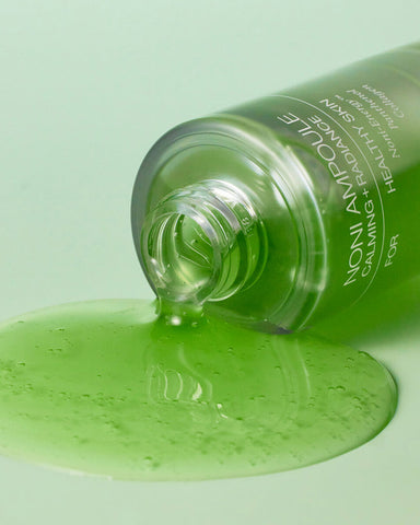 Green skincare product with a visible brand name on a light green background