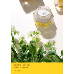 Jar of Honey Glow Cream with flowers on a white background