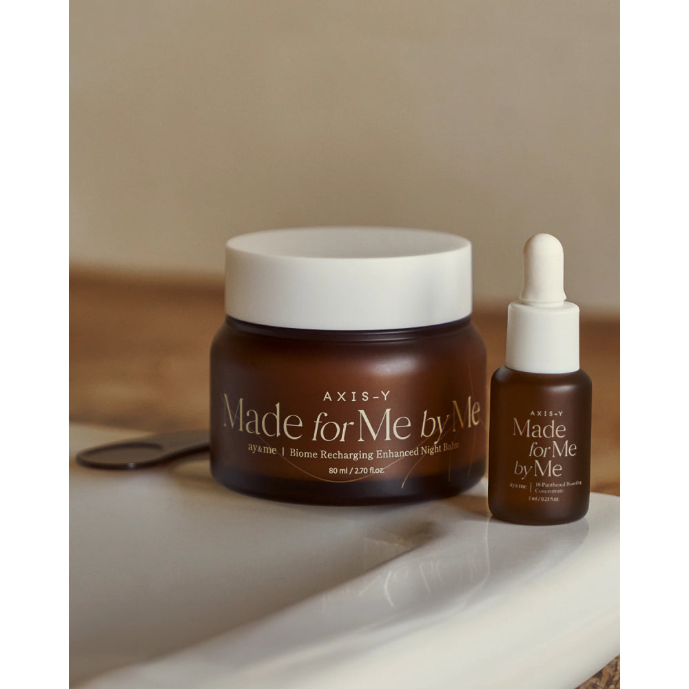  AXIS-Y skincare products including a jar and dropper bottle on a neutral background