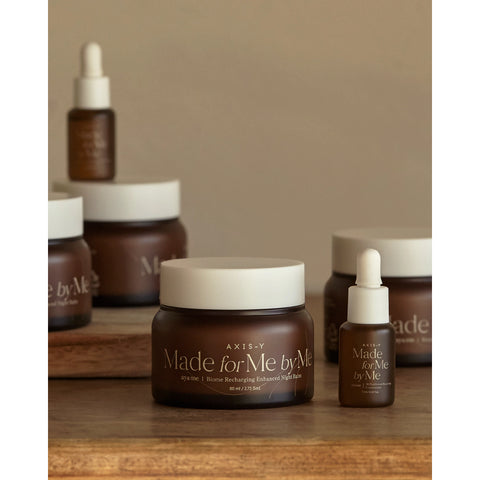 Skincare products with 'Made for Me by Me' branding on a wooden surface.