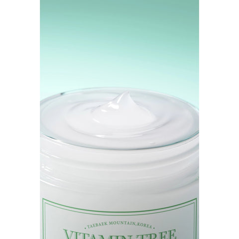 Jar of cream with a green label on a light green background