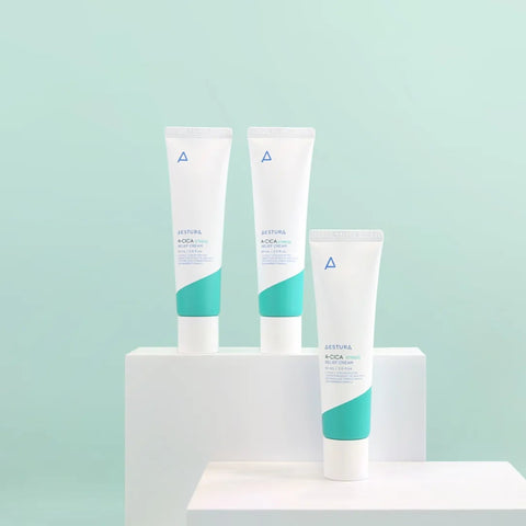 Three skincare products on a white stand against a light blue background