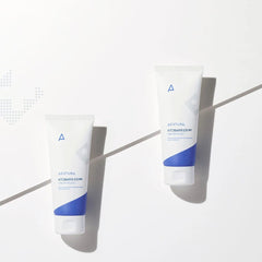 Two skincare products with blue and white design on a light gray background