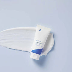 Tube of cream with a white applicator on a light blue background