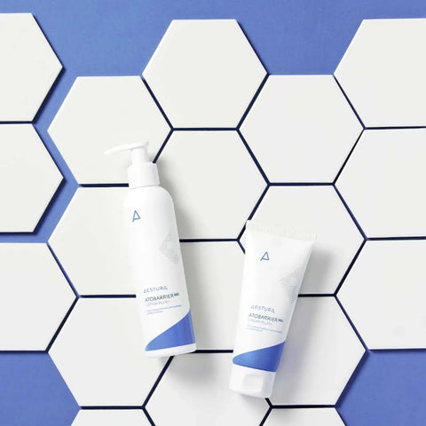 Two skincare products on a hexagonal tile pattern with a blue background