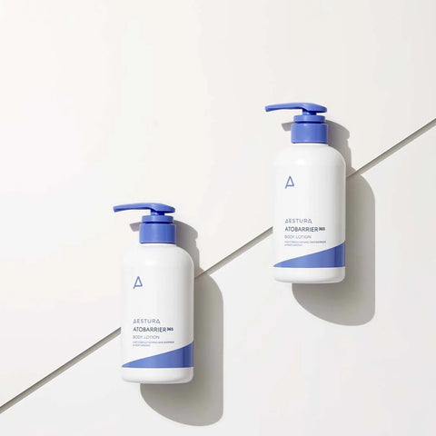 Two bottles of shampoo with blue and white design on a light gray background