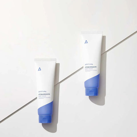 Two blue and white skincare products on a light gray surface with a geometric pattern.