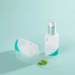 Two skincare bottles on a light blue background