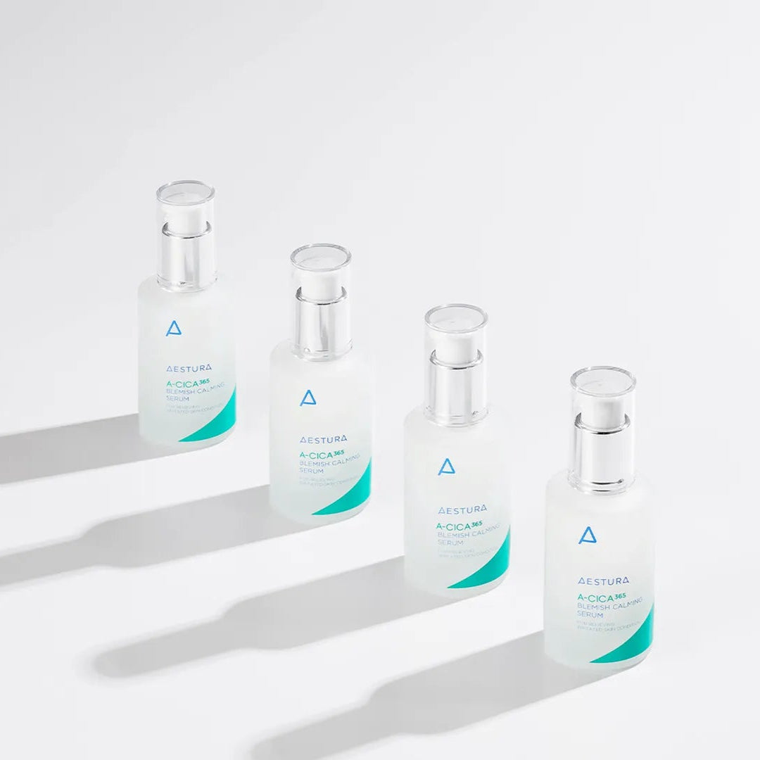Four glass vials with green labels on a white background