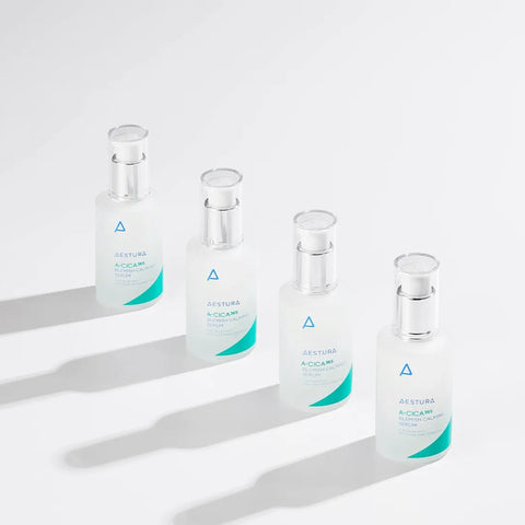 Four glass vials with green labels on a white background