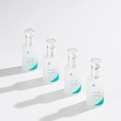 Four glass vials with green labels on a white background