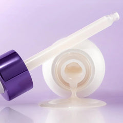 Cosmetic applicator with purple handle and white shaft on a light purple background
