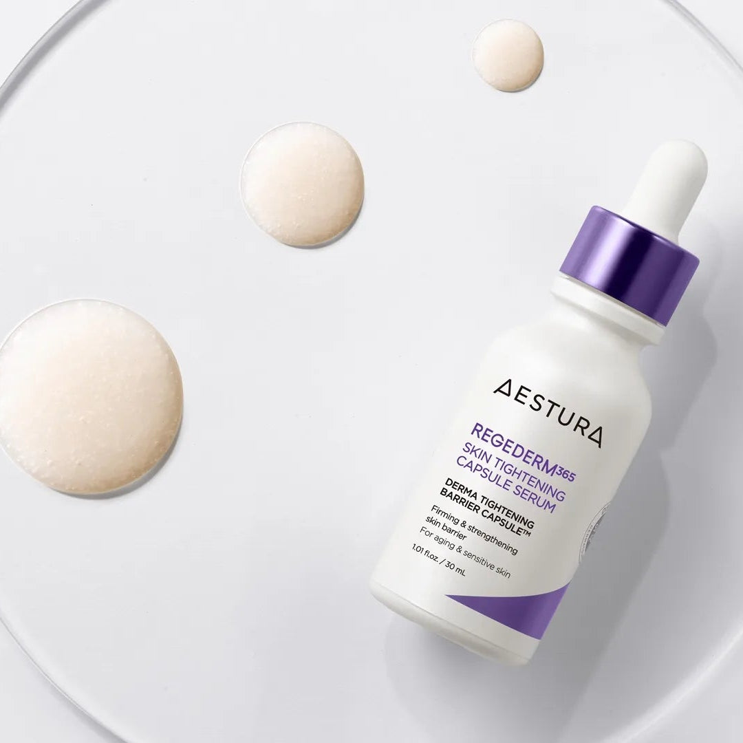 Aestura skincare serum bottle with droplets on a white background