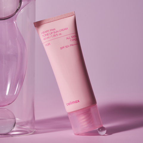 Pink tube of celimax sunscreen cream on a pink background