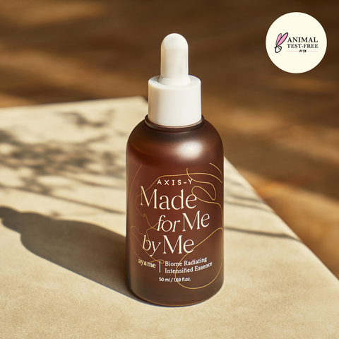 Brown bottle with dropper labeled 'Made for Me by Me' on a wooden surface, with 'Animal Test-Free' logo.