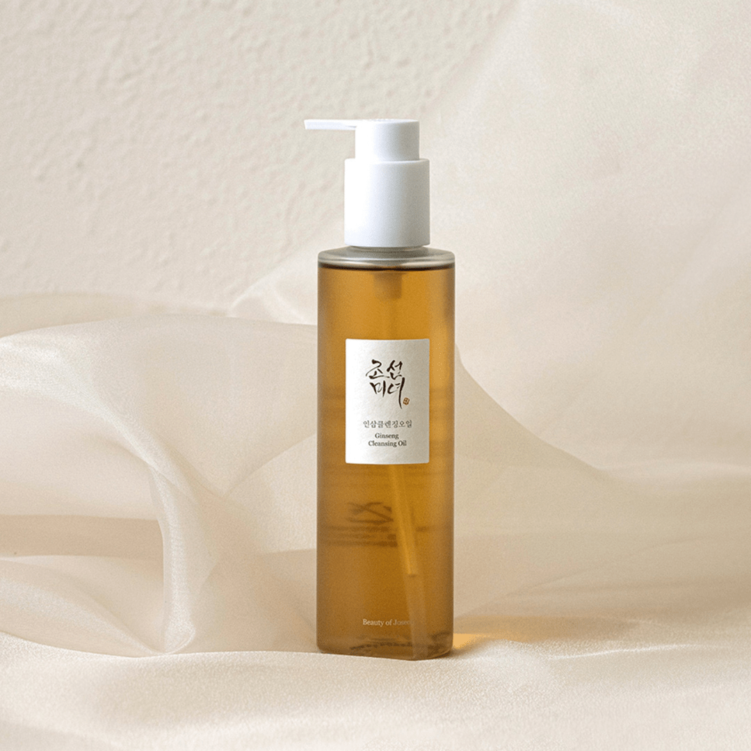 Bottle of cleansing oil with a pump on a soft beige background