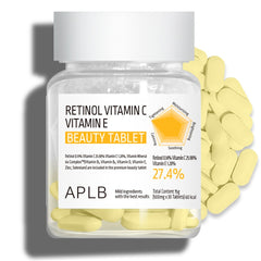 Bottle of Retinol Vitamin C and Vitamin E beauty tablets with scattered tablets on a white background