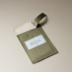Green sheet mask with a label on a beige background