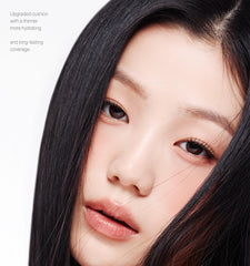 Close-up of a person with long dark hair and fair skin on a white background