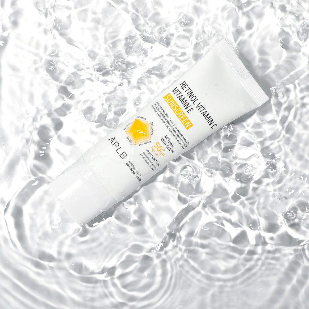 Two tubes of sunscreen with visible branding on a water background
