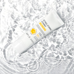 Two tubes of sunscreen with visible branding on a water background