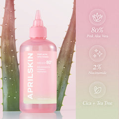Pink skincare bottle with aloe vera leaves and product packaging on a light pink background