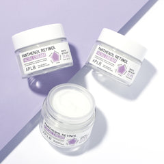 Three jars of APLB Panthenol Retinol cream on a light purple background