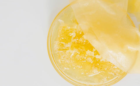Close-up of a yellow jelly-like dessert with a white background