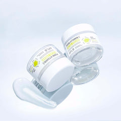 Two skincare jars with a clear background