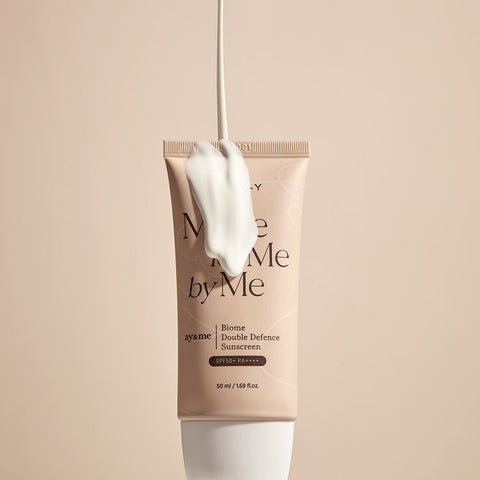 Sunscreen cream packaging with a applicator on a beige background