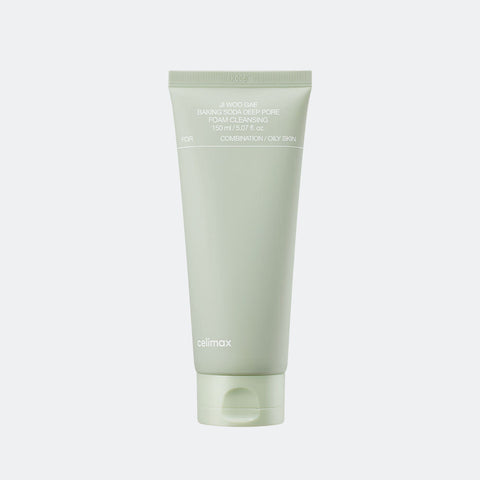 Green tube of skincare product on a light gray background