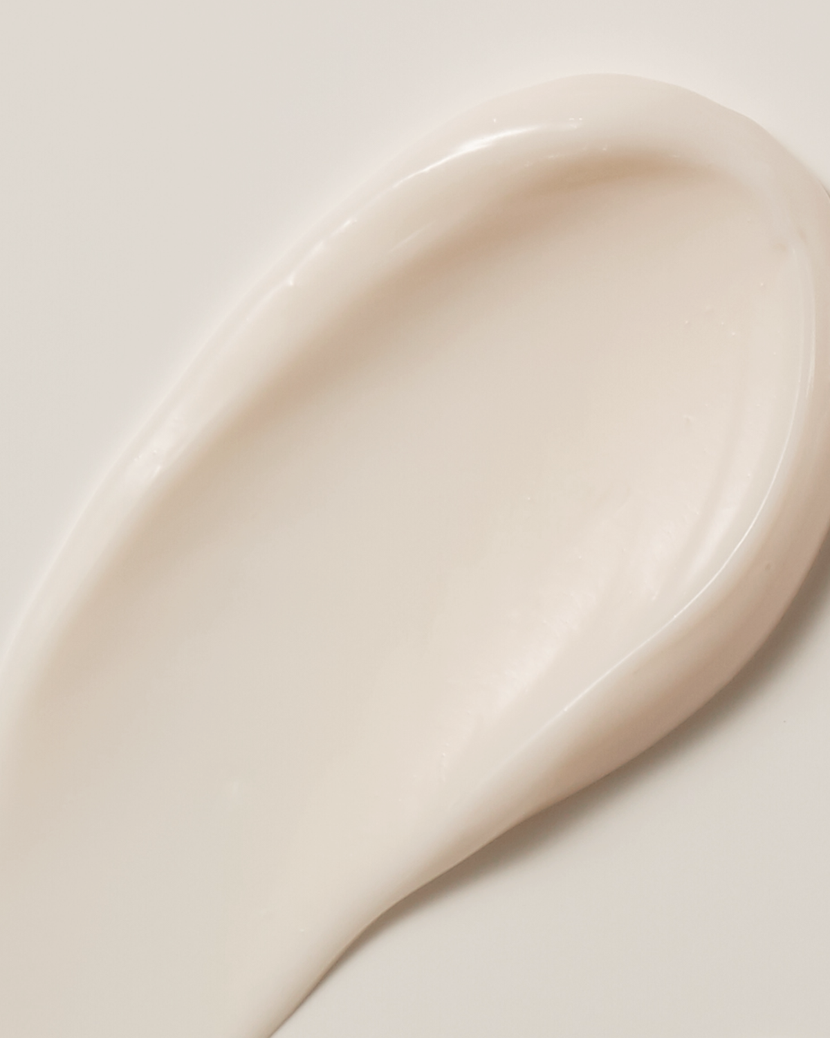 Close-up of a white ceramic spoon on a light background