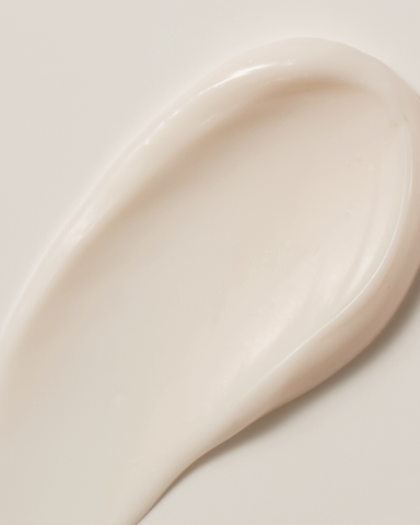 Close-up of a white ceramic spoon on a light background