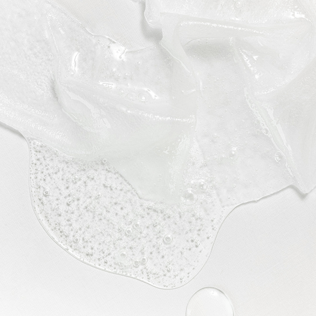 Close-up of white slime with bubbles on a light gray background