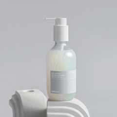 Bottle of Cellmax skincare product on a gray background