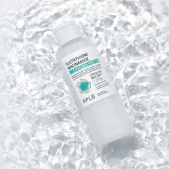 Bottle of skincare product with 'APLB' branding on a water background