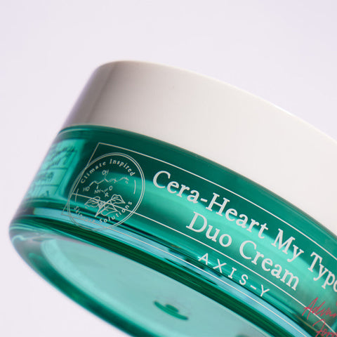Green skincare cream jar with white text on a light gray background