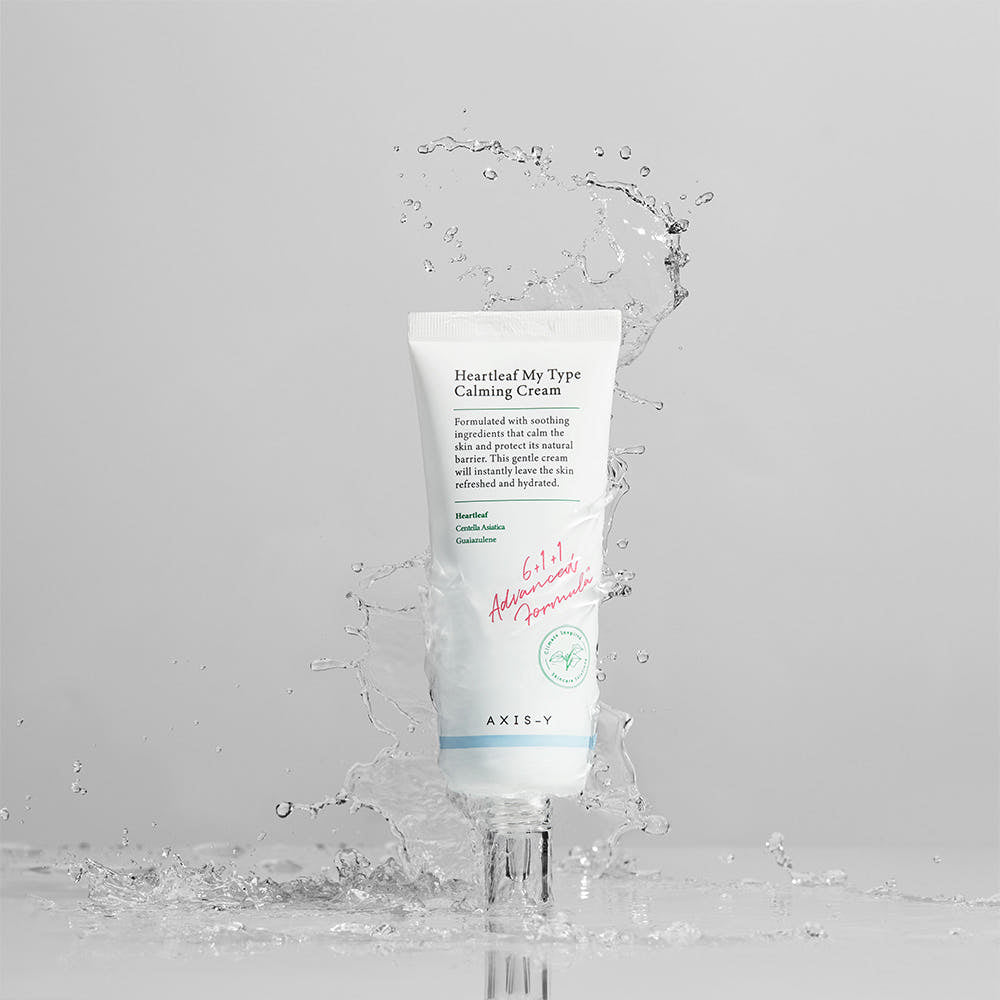 Tube of AXE-Y Heartleaf My Type Calming Cream with water droplets on a light gray background