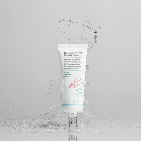 Tube of AXE-Y Heartleaf My Type Calming Cream with water droplets on a light gray background