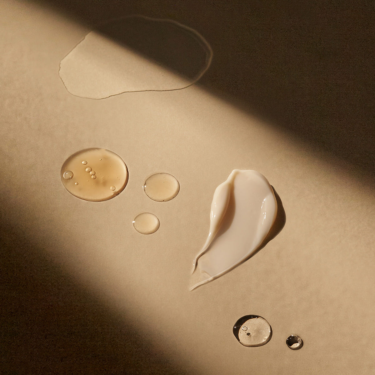 Close-up of different cosmetic textures on a beige background