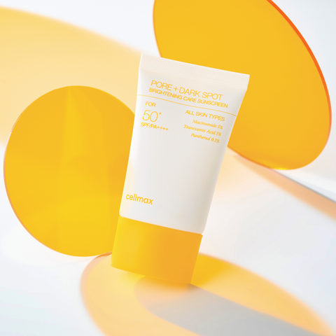 Sunscreen tube with yellow and white design on a light background